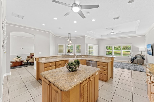 kitchen featuring a sink, dishwasher, a ceiling fan, open floor plan, and a spacious island