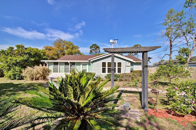 back of house featuring stucco siding and a sunroom