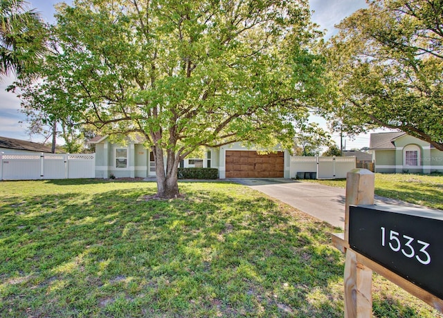 obstructed view of property with a front yard, a gate, fence, driveway, and an attached garage