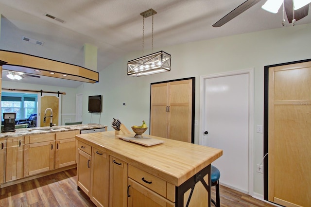 kitchen featuring visible vents, ceiling fan, light brown cabinetry, wood finished floors, and wood counters
