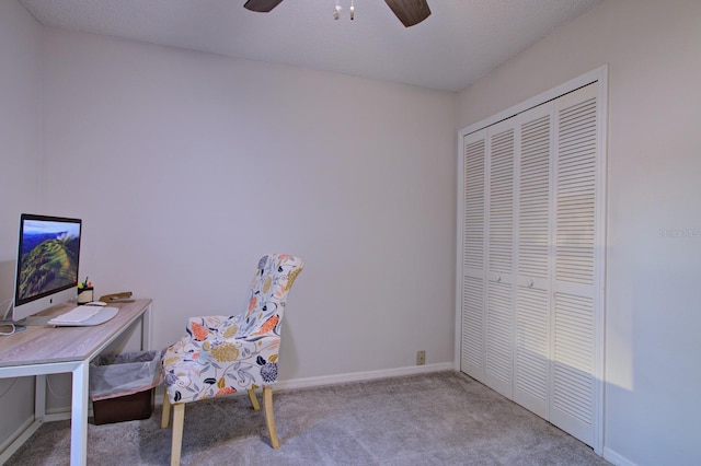unfurnished office with baseboards, carpet floors, and ceiling fan