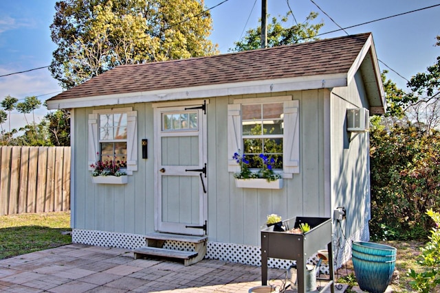 view of shed featuring fence