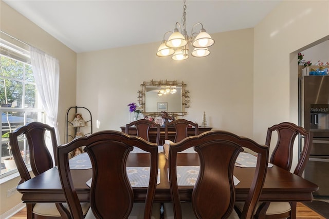 723 Pelican Ct, Kissimmee, FL 34759 - dining room featuring a chandelier and wood finished floors