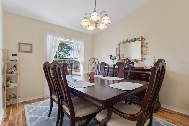 723 Pelican Ct, Kissimmee, FL 34759 - dining space featuring baseboards, a notable chandelier, and light wood-style flooring