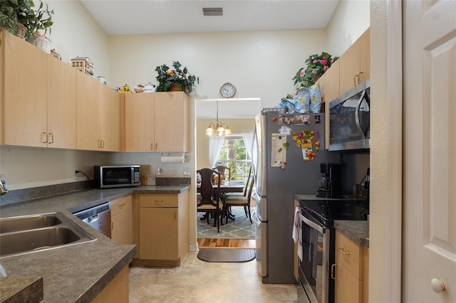 723 Pelican Ct, Kissimmee, FL 34759 - kitchen featuring visible vents, dark countertops, appliances with stainless steel finishes, and light brown cabinets