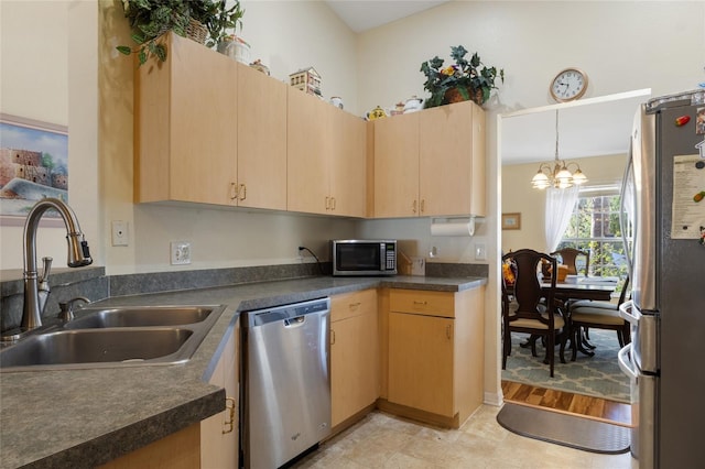 723 Pelican Ct, Kissimmee, FL 34759 - kitchen featuring light brown cabinetry, appliances with stainless steel finishes, dark countertops, and a sink