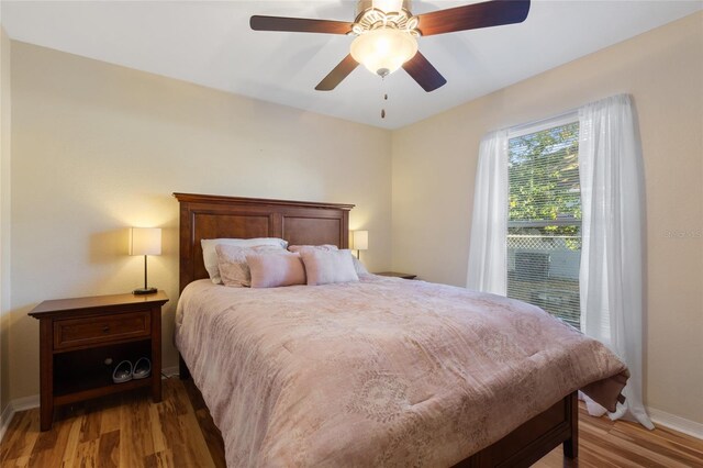 723 Pelican Ct, Kissimmee, FL 34759 - bedroom featuring a ceiling fan, wood finished floors, and baseboards