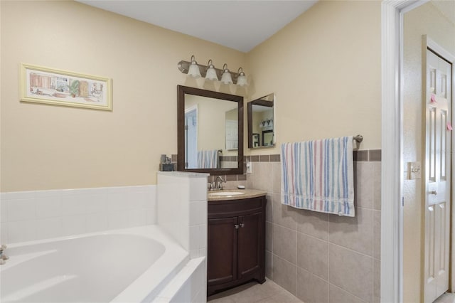 723 Pelican Ct, Kissimmee, FL 34759 - full bathroom featuring a bath, tile patterned flooring, vanity, and tile walls