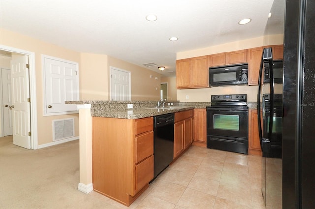 kitchen with visible vents, a peninsula, recessed lighting, brown cabinets, and black appliances