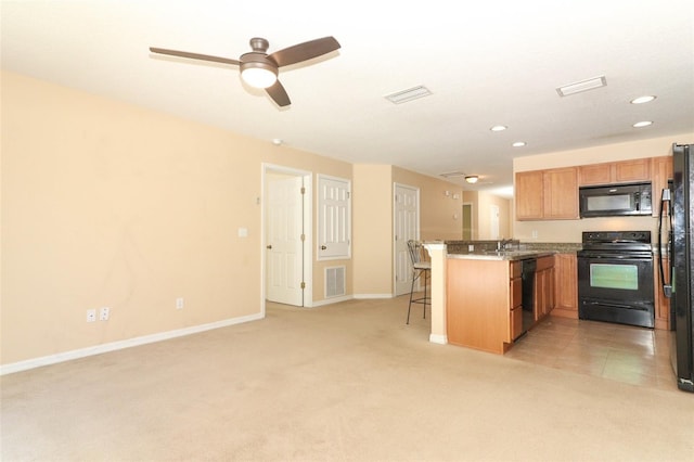 kitchen with a peninsula, visible vents, light carpet, and black appliances