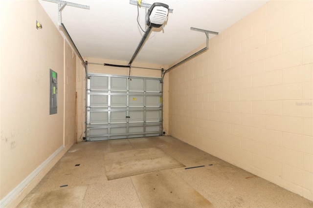 garage featuring a garage door opener, electric panel, and concrete block wall