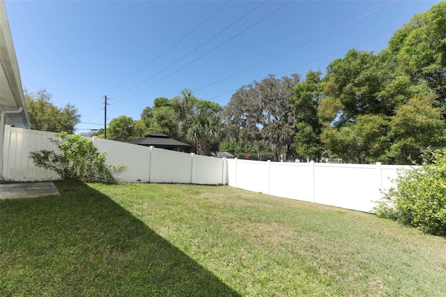 view of yard with a fenced backyard