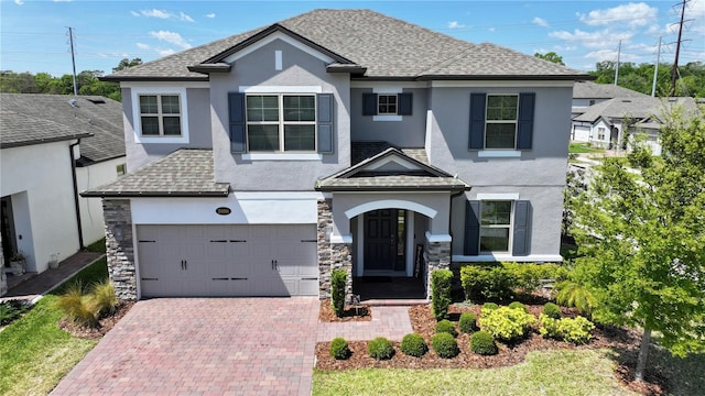 2090 Prairie Sage Ln, Longwood, FL 32750 - traditional home with a garage, decorative driveway, stucco siding, and roof with shingles