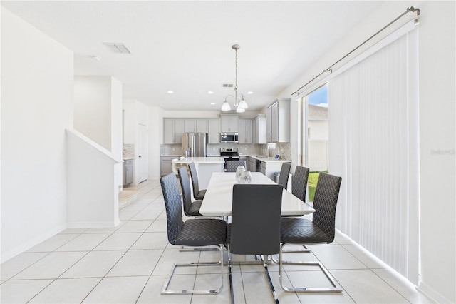 2090 Prairie Sage Ln, Longwood, FL 32750 - dining room featuring light tile patterned floors, visible vents, baseboards, recessed lighting, and a notable chandelier