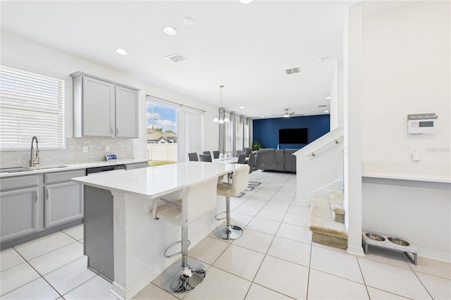 2090 Prairie Sage Ln, Longwood, FL 32750 - kitchen featuring open floor plan, light tile patterned floors, a sink, and gray cabinetry