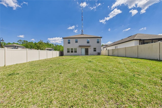 2090 Prairie Sage Ln, Longwood, FL 32750 - back of property featuring a lawn, a fenced backyard, and central AC