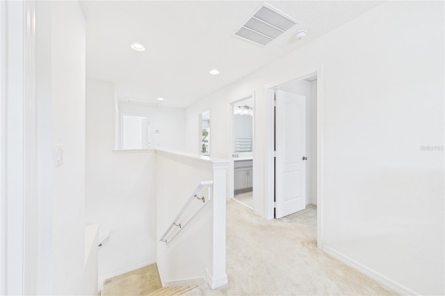 2090 Prairie Sage Ln, Longwood, FL 32750 - hall with an upstairs landing, baseboards, light colored carpet, and visible vents