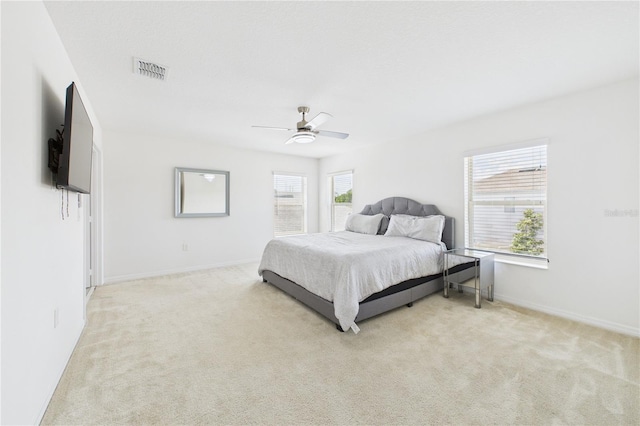 2090 Prairie Sage Ln, Longwood, FL 32750 - bedroom with light carpet, baseboards, visible vents, and ceiling fan