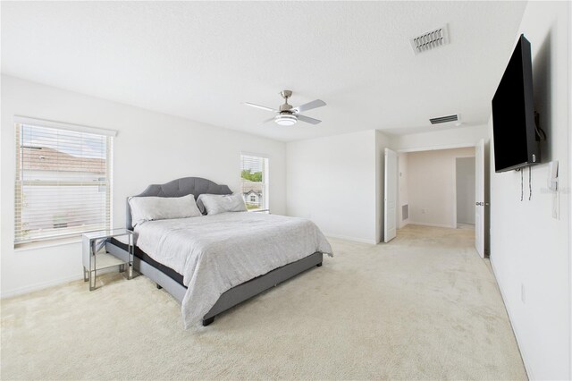 2090 Prairie Sage Ln, Longwood, FL 32750 - bedroom with light carpet, baseboards, visible vents, and a ceiling fan