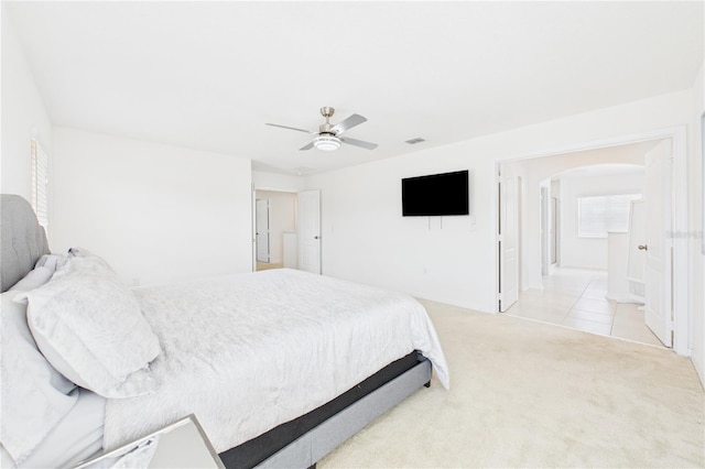 2090 Prairie Sage Ln, Longwood, FL 32750 - carpeted bedroom featuring arched walkways, ceiling fan, visible vents, and tile patterned flooring