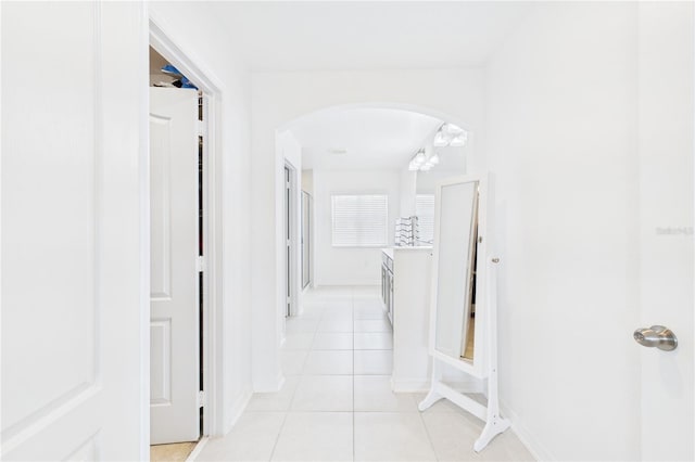 2090 Prairie Sage Ln, Longwood, FL 32750 - hall with light tile patterned floors, arched walkways, and baseboards