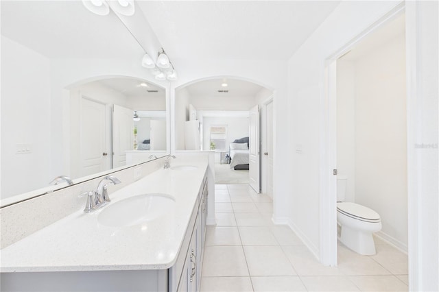 2090 Prairie Sage Ln, Longwood, FL 32750 - ensuite bathroom featuring double vanity, toilet, tile patterned flooring, and a sink