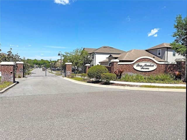 2090 Prairie Sage Ln, Longwood, FL 32750 - view of street with street lights, a gated entry, a gate, and curbs