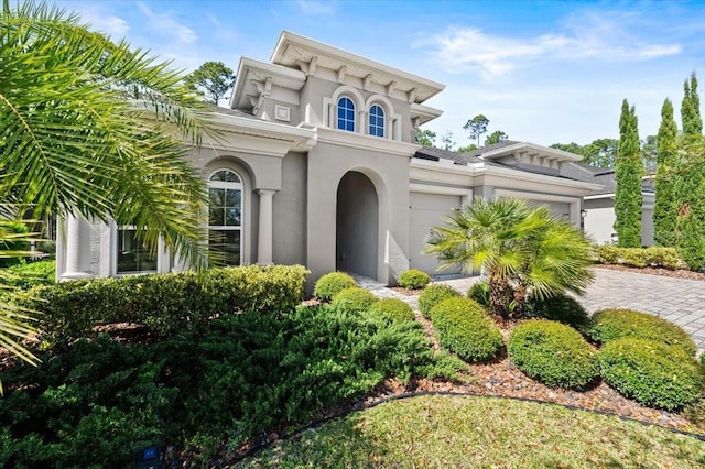 354 Stirling Bridge Dr, Ormond Beach, FL 32174 - view of front of home featuring an attached garage, stucco siding, and decorative driveway