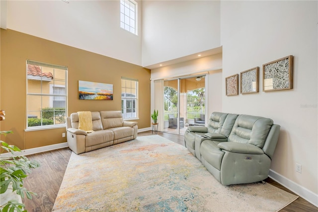 3145 Connemara Dr, Ormond Beach, FL 32174 - living room featuring wood finished floors, baseboards, and a high ceiling