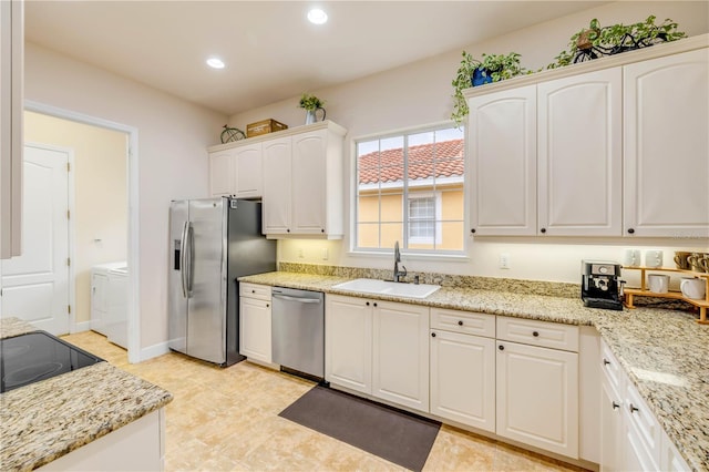 3145 Connemara Dr, Ormond Beach, FL 32174 - kitchen with a sink, appliances with stainless steel finishes, recessed lighting, white cabinetry, and light stone counters
