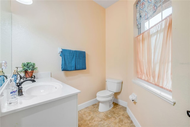 3145 Connemara Dr, Ormond Beach, FL 32174 - bathroom featuring toilet, baseboards, vanity, and tile patterned floors