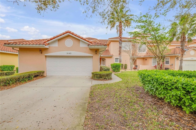 3145 Connemara Dr, Ormond Beach, FL 32174 - view of front of house featuring stucco siding, an attached garage, driveway, and a tiled roof