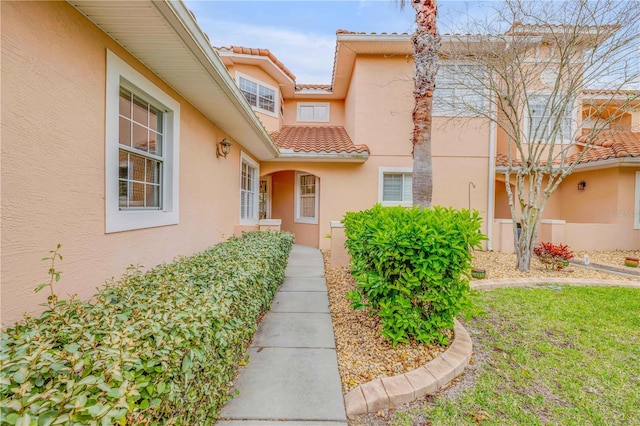 3145 Connemara Dr, Ormond Beach, FL 32174 - property entrance with stucco siding and a tile roof