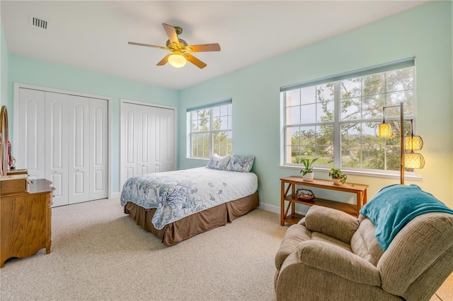 3145 Connemara Dr, Ormond Beach, FL 32174 - carpeted bedroom with two closets, baseboards, and a ceiling fan