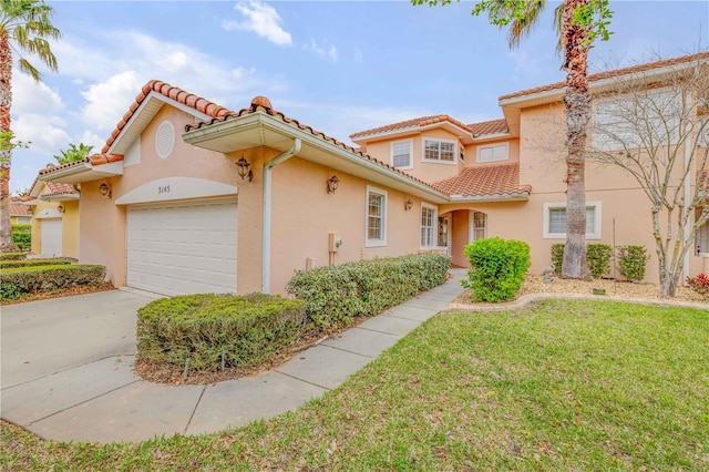 3145 Connemara Dr, Ormond Beach, FL 32174 - mediterranean / spanish-style home featuring a garage, stucco siding, a front yard, and a tiled roof