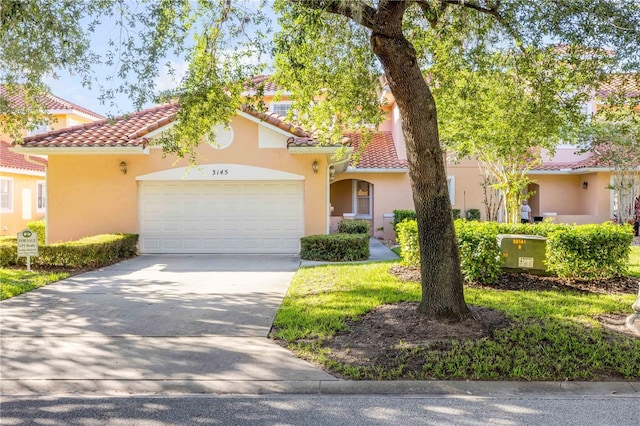 3145 Connemara Dr, Ormond Beach, FL 32174 - mediterranean / spanish-style home featuring concrete driveway, a tiled roof, an attached garage, and stucco siding