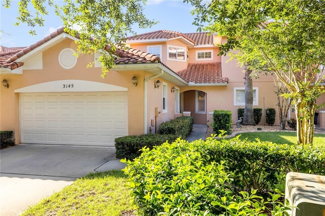 3145 Connemara Dr, Ormond Beach, FL 32174 - mediterranean / spanish-style house featuring a tile roof, a garage, driveway, and stucco siding
