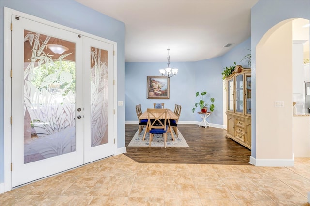 3145 Connemara Dr, Ormond Beach, FL 32174 - entryway featuring arched walkways, a chandelier, and french doors