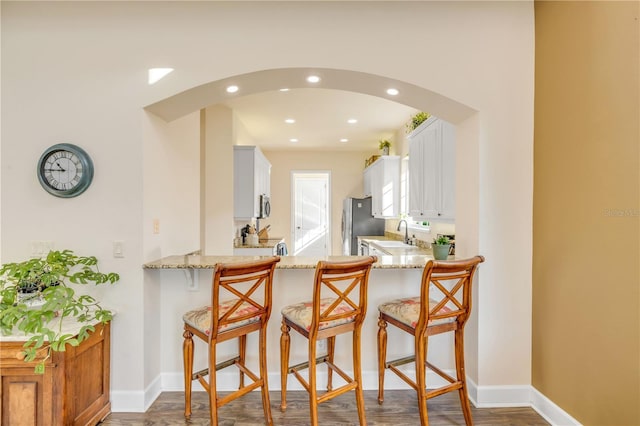 3145 Connemara Dr, Ormond Beach, FL 32174 - kitchen featuring light stone countertops, stainless steel appliances, a peninsula, and recessed lighting