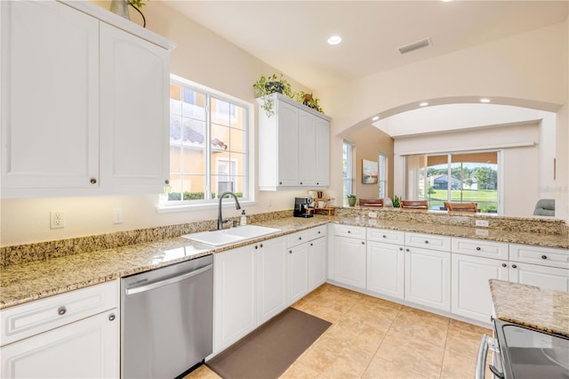 3145 Connemara Dr, Ormond Beach, FL 32174 - kitchen with stainless steel dishwasher, healthy amount of natural light, arched walkways, stove, and recessed lighting