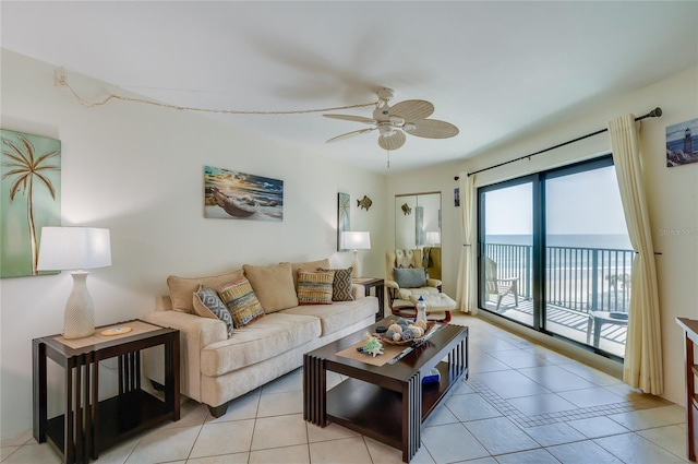 living area with light tile patterned floors and a ceiling fan