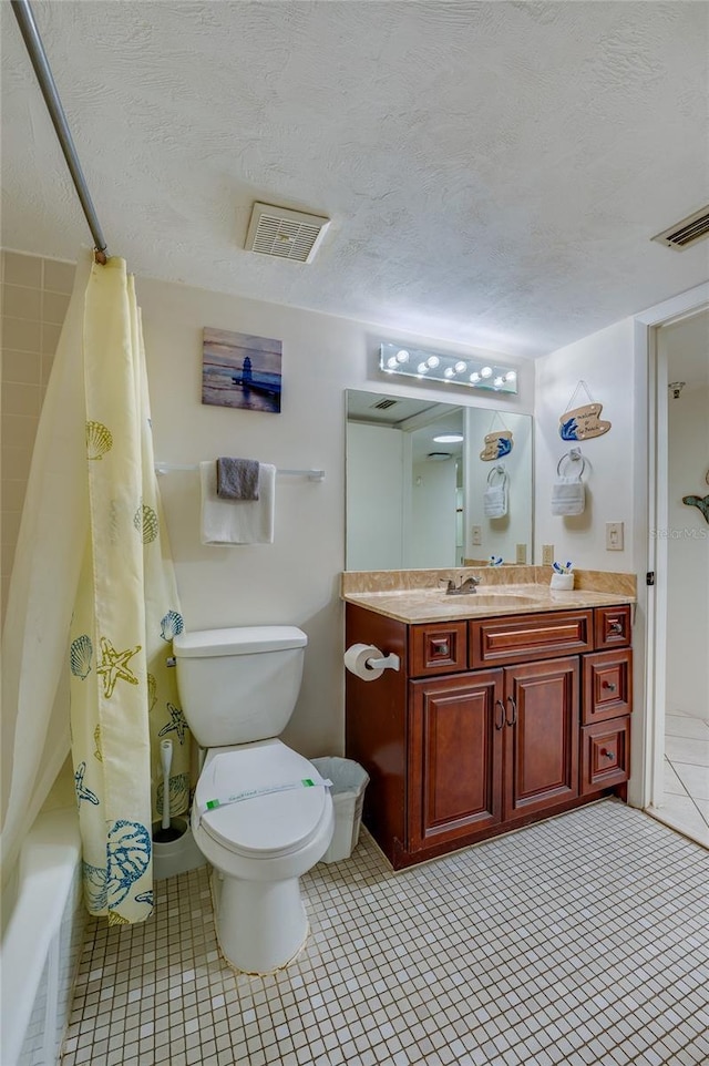 bathroom with toilet, a textured ceiling, vanity, and visible vents