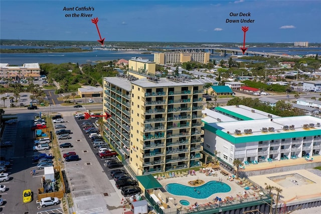 birds eye view of property with a water view and a city view