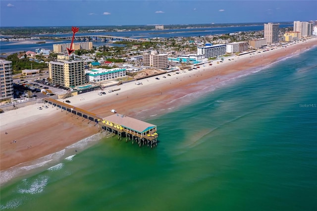 birds eye view of property featuring a water view, a city view, and a beach view