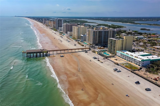 birds eye view of property with a water view, a beach view, and a city view
