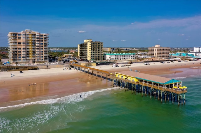 birds eye view of property with a water view and a beach view