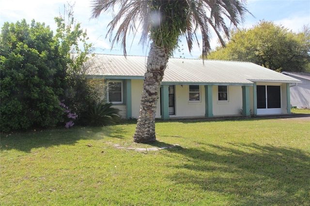 single story home with metal roof and a front yard