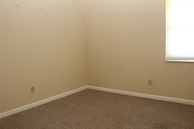 spare room with carpet flooring and baseboards