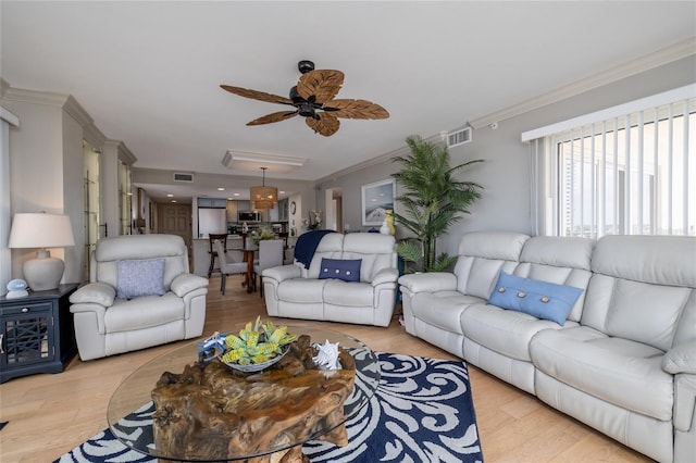 2967 S Atlantic Ave Unit 301, Daytona Beach Shores, FL 32118 - living room with ornamental molding, ceiling fan, and light wood-type flooring