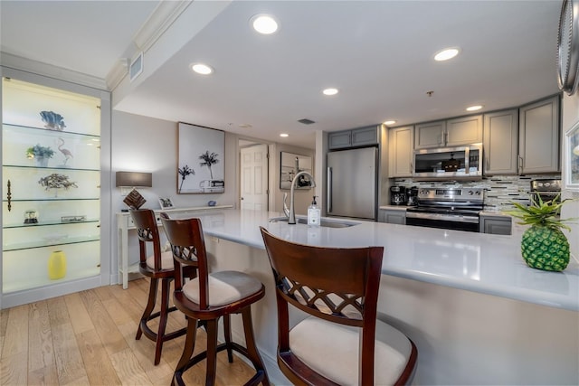 2967 S Atlantic Ave Unit 301, Daytona Beach Shores, FL 32118 - kitchen with appliances with stainless steel finishes, a sink, gray cabinetry, light countertops, and recessed lighting